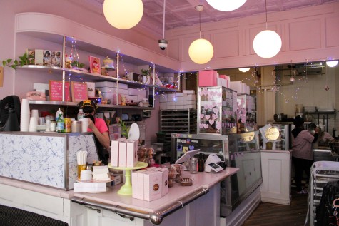 The interior of Erin McKenna’s Bakery with moon-shaped lights and pink walls.