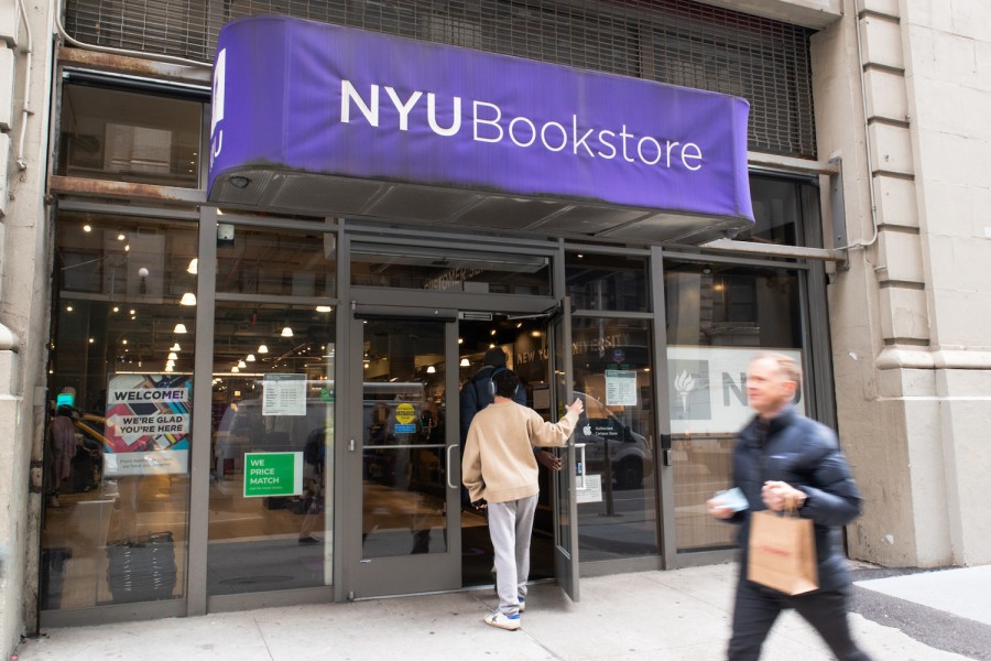 A student walks through the N.Y.U Bookstore entrance.