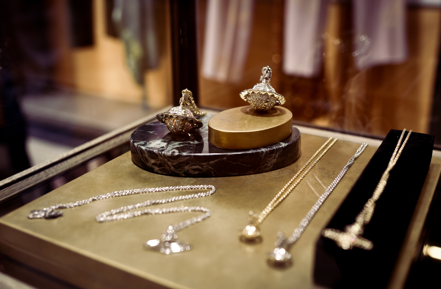 The jewelry display inside the Vivienne Westwood New York City store. Two orb pendants take prominence in the photo.