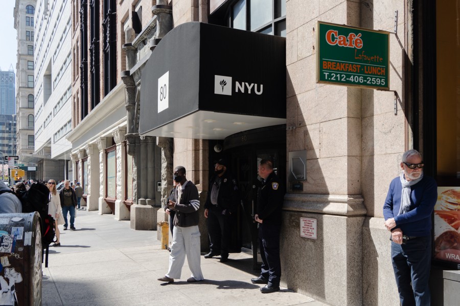The entrance to N.Y.U's Lafayette residence hall with three campus safety officers standing at the entrance.