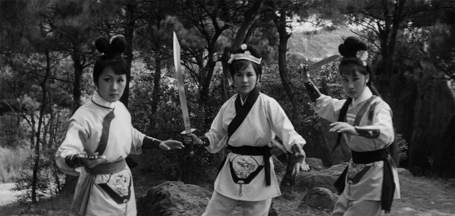 A black-and-white image from the film “Vengeance of the Phoenix Sisters,” with three women holding swords in different postures.