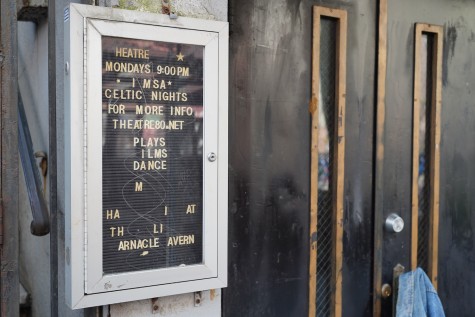 A black letter board with white letters that are falling off outside of Theatre Eighty Saint Marks.