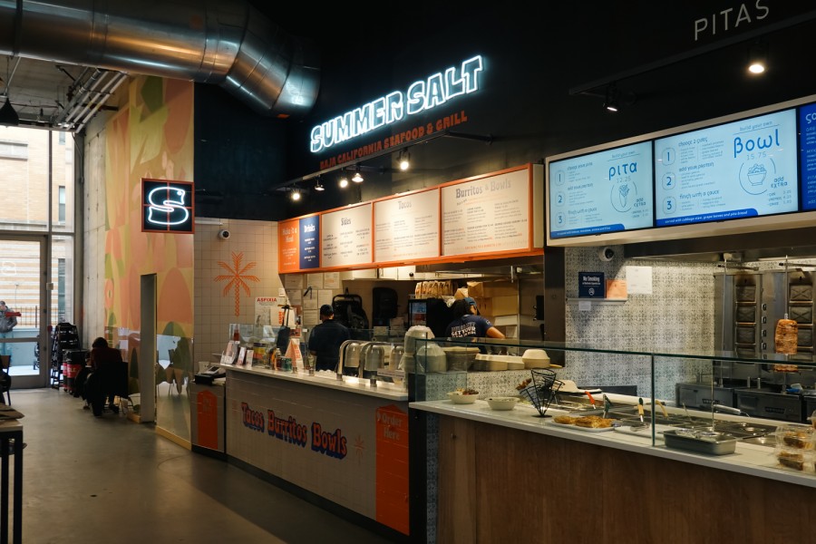 The Summer Salt booth in an indoor space with signs that read “Summer Salt,” “Baja California Seafood ampersand Grill” and “Tacos, Burritos, Bowls.”