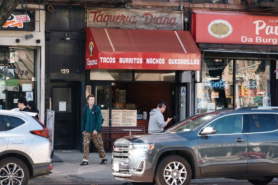 The exterior of Taqueria Diana with a red awning and text that reads “Tacos, Burritos, Nachos, Quesadillas.”