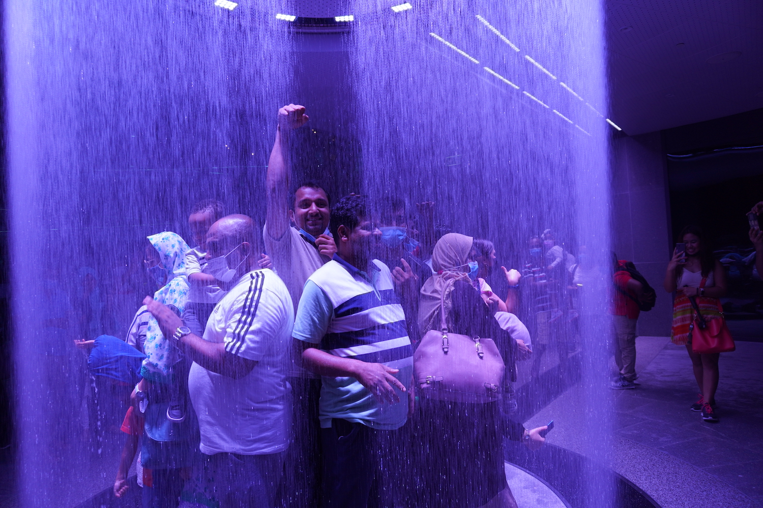 Guests enjoy the rain fountain at the Saudi Arabia pavilion at Expo 2020 Dubai.