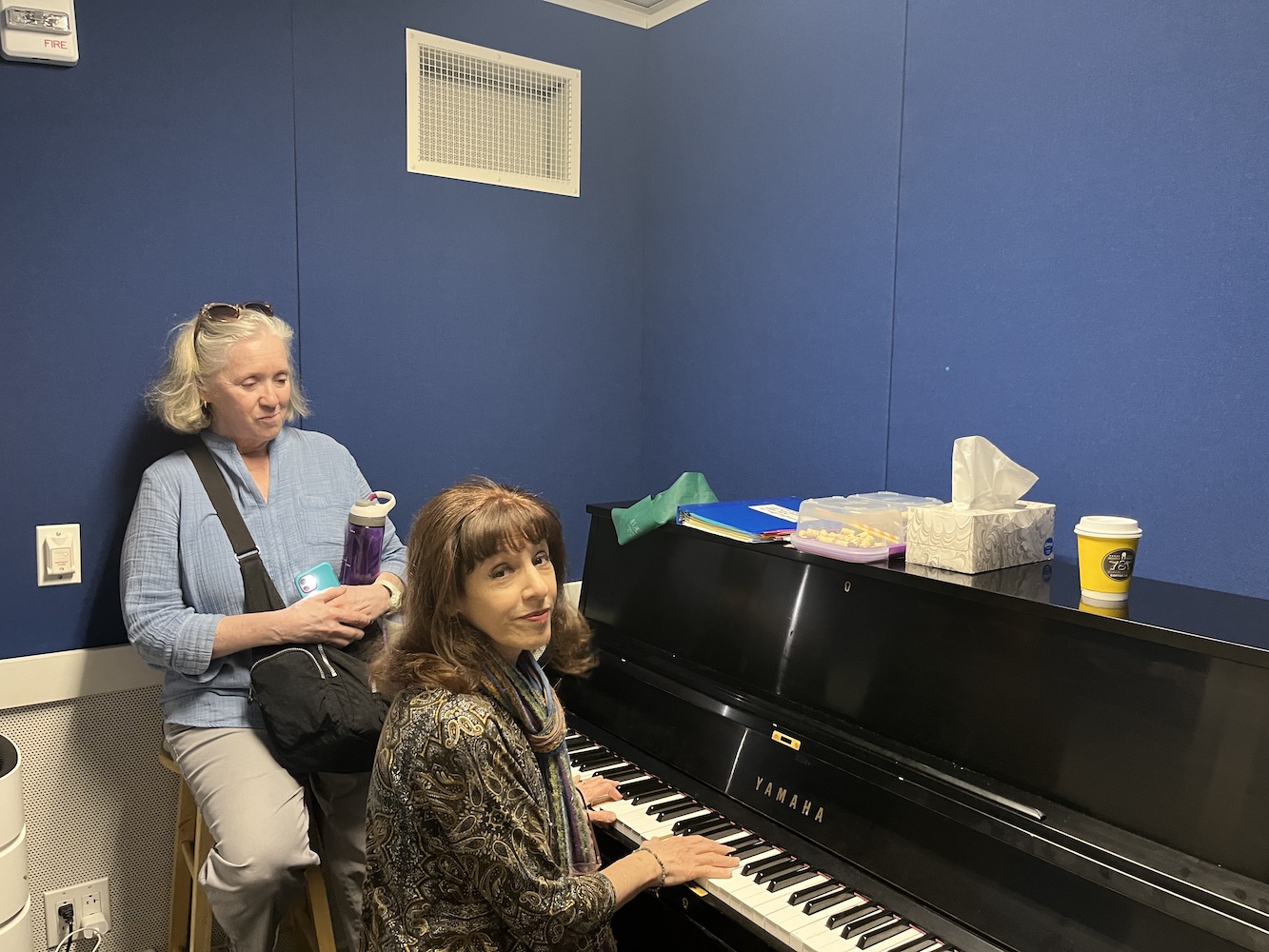 Melanie Vaughan and Michelle Rosen sit in a practice room.
