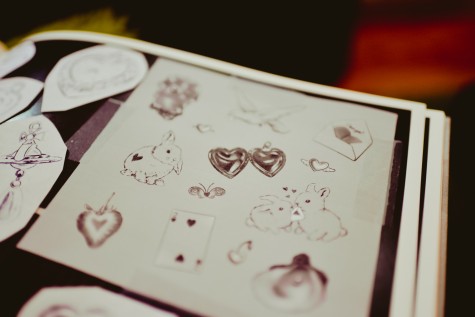 A book of Satterwhite’s flash tattoo designs, including a page filled with bunny flashes and a heart pendant design.