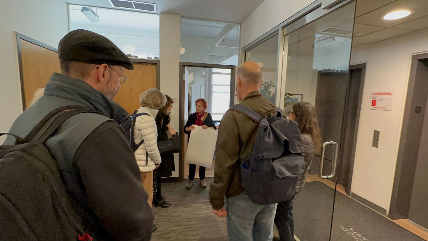 Adjunct faculty members of the Tisch School of the Arts handing a copy of their petition to Klara Palotai, the program coordinator for Allyson Green, the dean of the Tisch School of the Arts. 3