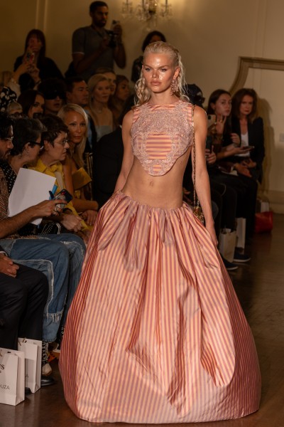 A model wears a dark and light pink accented dress.