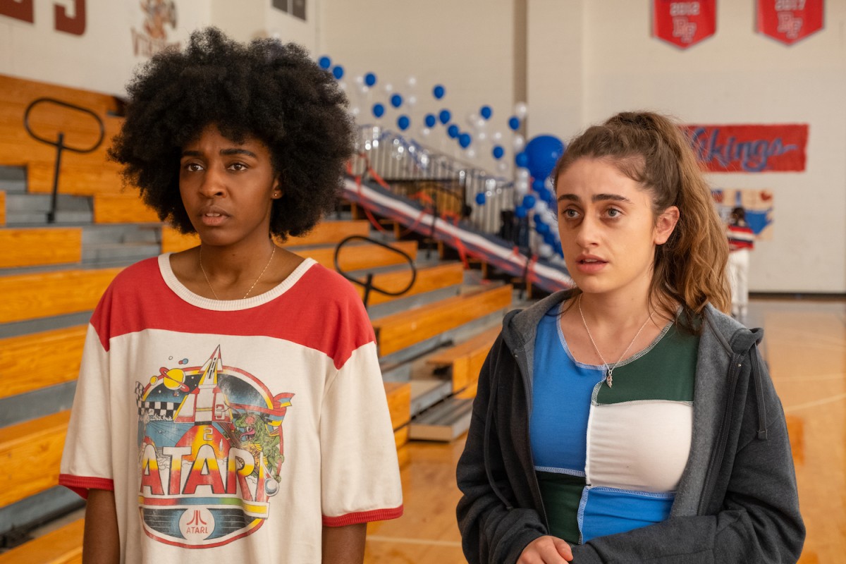 Actresses Ayo Edebiri and Rachel Sennott as characters Josie and P.J. in the film “Bottoms.” They are standing in an indoor basketball court.