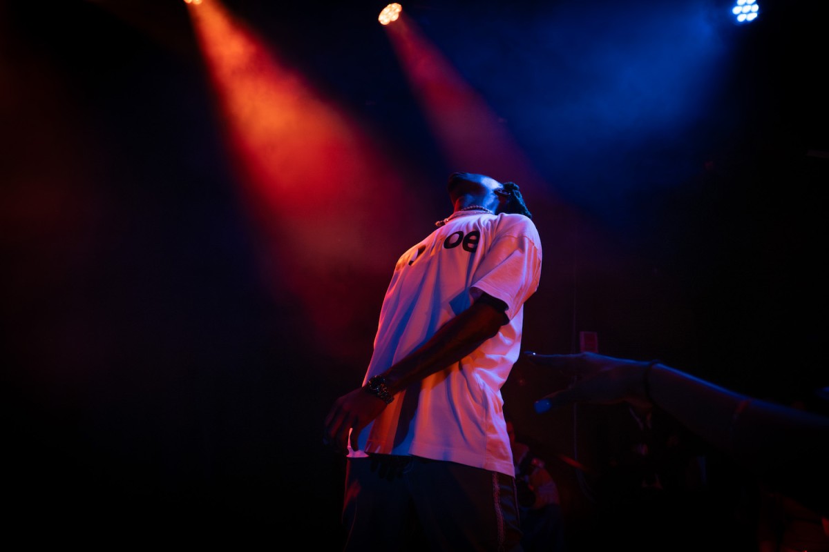 Artist TisaKorean rapping on stage.