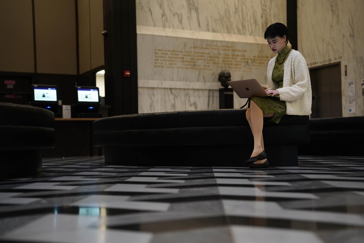 Heather Guo studies on a bench in Bobst Library.