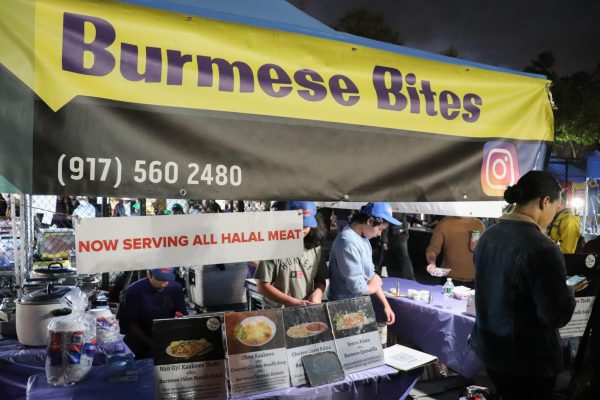 A food stall with a black and yellow banner that says “Burmese Bites”.