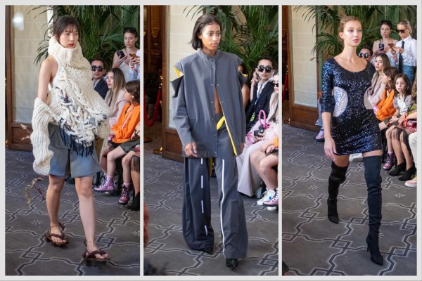 From left to right: a model wearing a gray oversized jacket and a pair of gray oversized pants with white and yellow accents; a model wearing a free-form, white knitted top and a pair of gray shorts; a model wearing a black sequin dress with white accents.