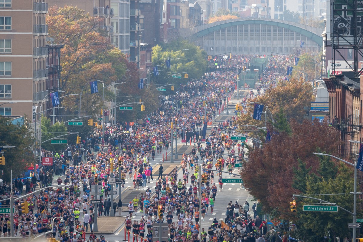 People run up Fourth Avenue in Brooklyn at the T.C.S N.Y.C. Marathon.