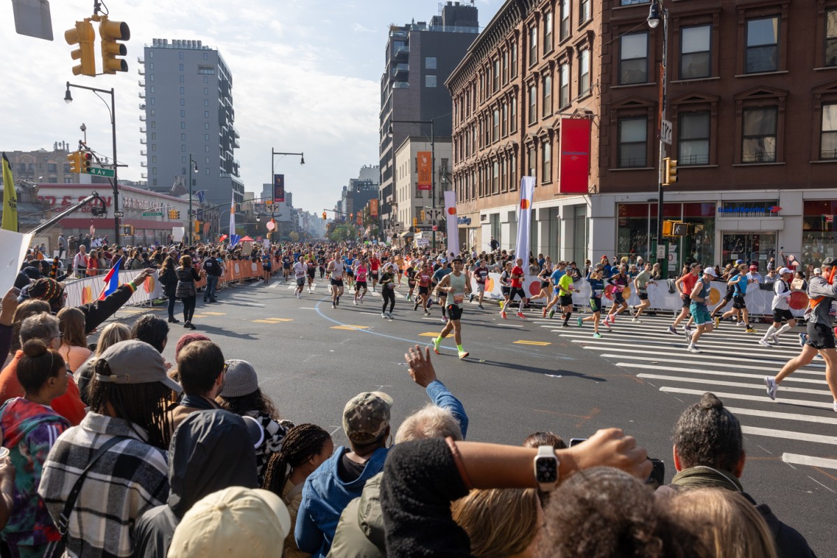 People round a corner onto Flatbush Avenue in Brooklyn at the T.C.S. N.Y.C. Marathon.