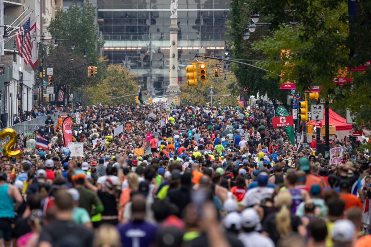 People in various colored outfits run along the length of Central Park South.