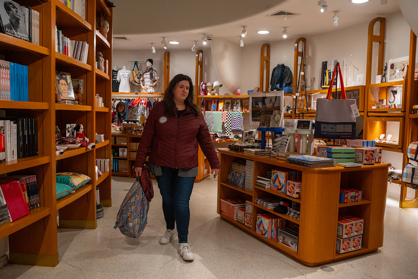 A woman walks through the aisle of the gift shop