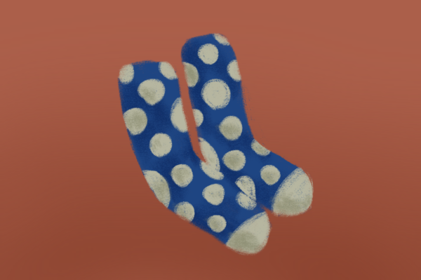 An illustration of blue socks with white spots on an orange background.