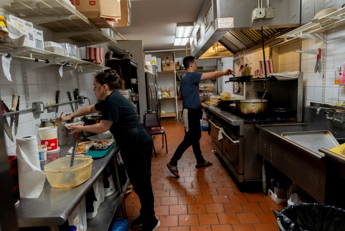 Dmytro Kovalenko and his co-worker busying themselves in the kitchen.