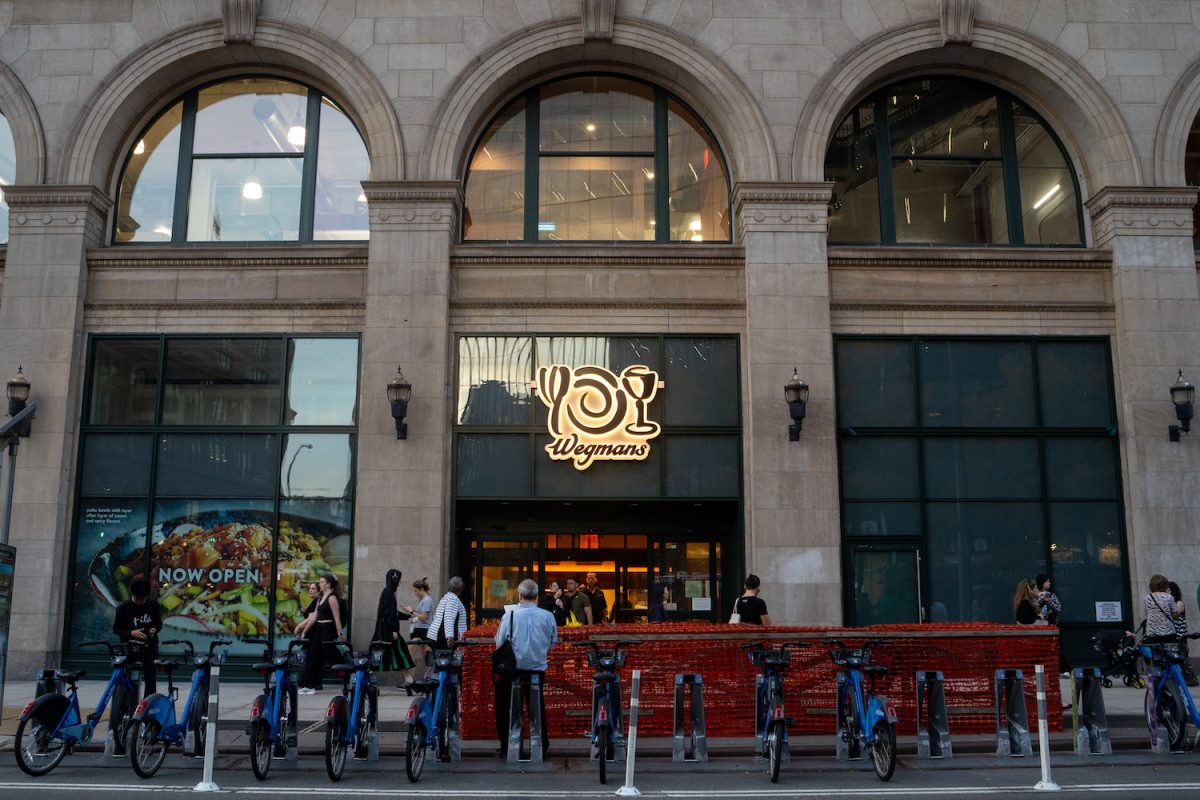 Wegmans+exterior+with+a+line+of+Citi+Bikes+in+front+of+a+red+fencing.