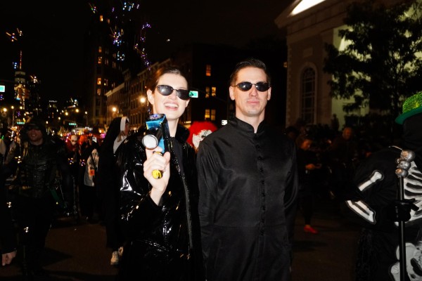 A man and a woman dressed as characters from The Matrix standing side by side.
