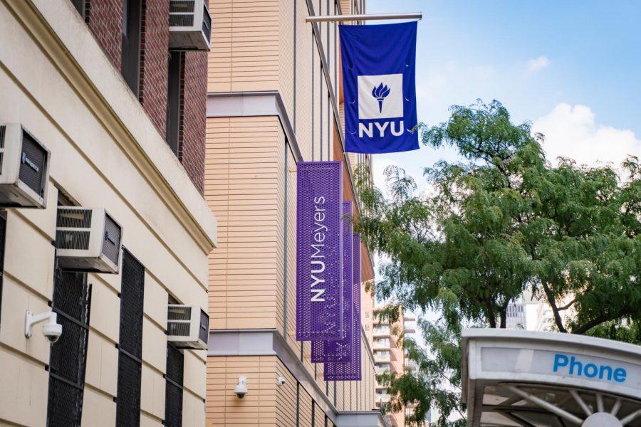 The exterior view of a building with three N.Y.U. banners that read “N.Y.U. Meyers”, “N.Y.U. Dentistry” and “N.Y.U. Engineering.”