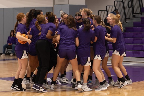 N.Y.U. women’s basketball huddles before its game against Johns Hopkins University.
