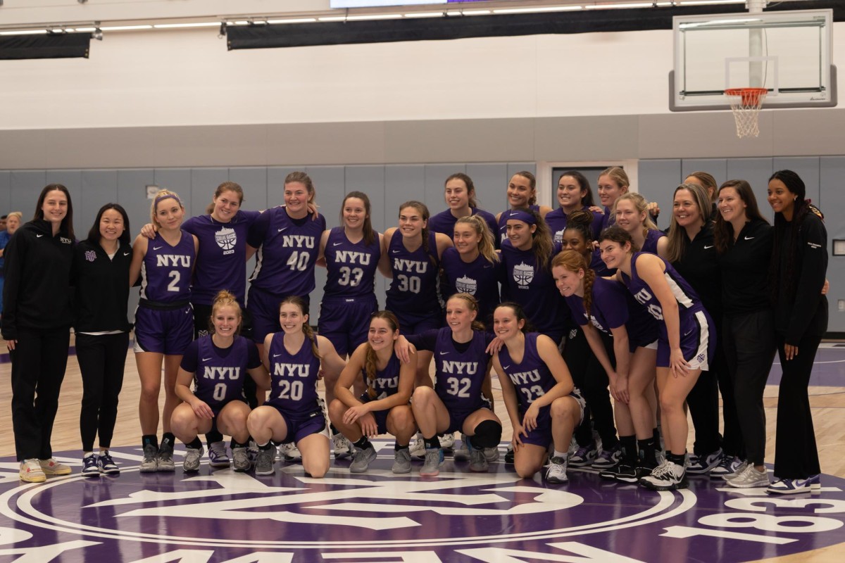 N.Y. U. women’s basketball team poses for a photo after its game against Johns Hopkins University.