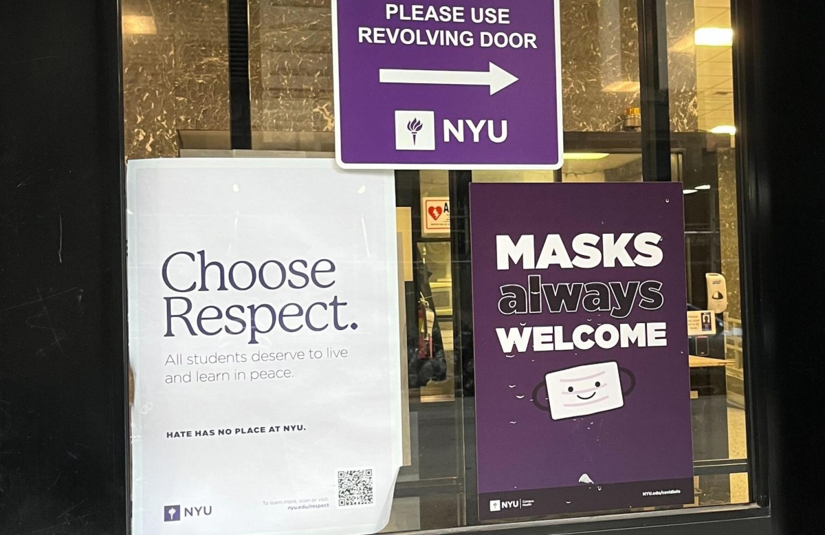 Various posters are stuck on a glass window. The poster on the left is white and reads “Choose Respect”.The poster on the right is purple and reads “Masks Always Welcome”. The poster on top is purple and reads “Please Use Revolving Door”.