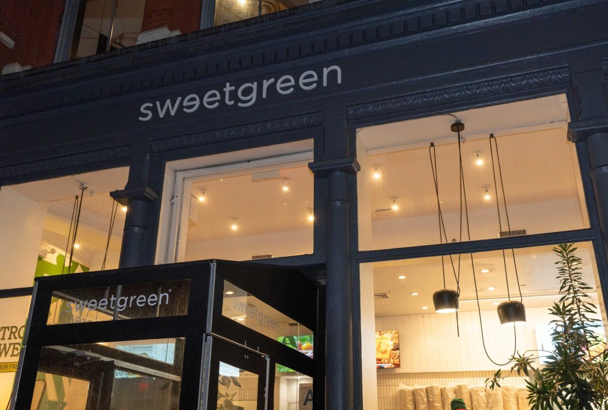 An image of a Sweetgreen storefront with a sign on the building that reads Sweetgreen.