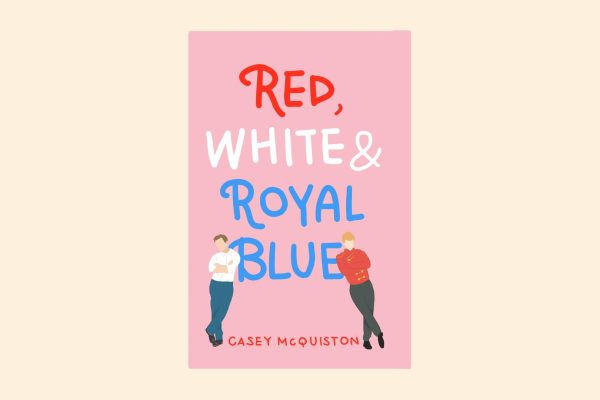 An illustration of a pink book with the title “RED, WHITE AND ROYAL BLUE” on it. Two men lean against the word "BLUE."
