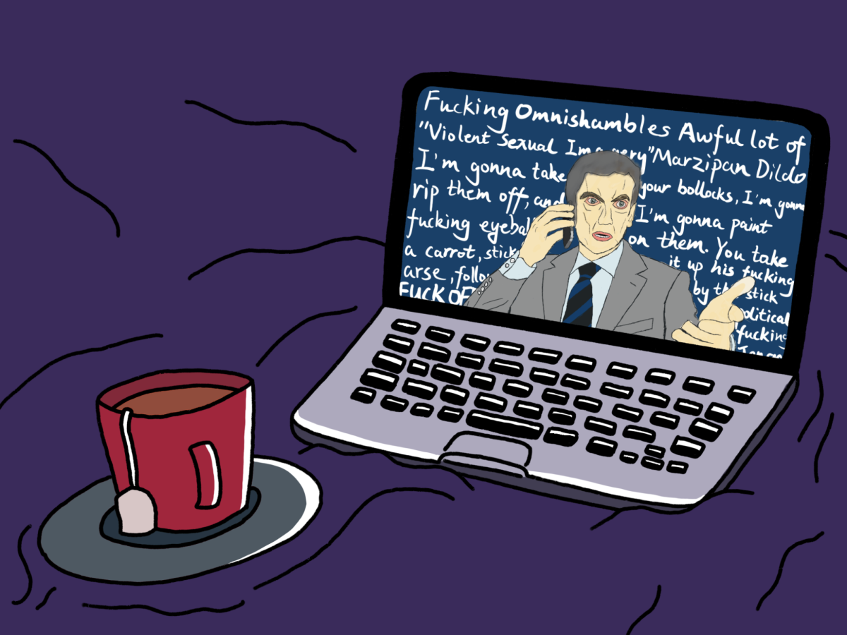 A+red+mug+and+a+laptop+on+a+purple+background.+On+the+screen%2C+a+man+wearing+a+suit+is+on+the+phone+with+white+words+filling+the+screen+behind+him.