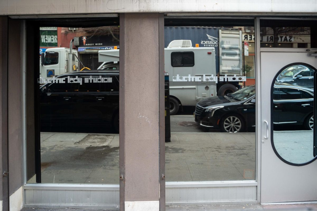 A front entrance with the text “Electric Lady Studios” written in a retro white font on two reflective walls.