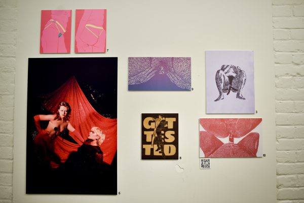 A collection of illustrations and a photo on a white wall.
