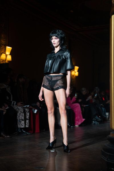 A model wears a leather top and short, sheer shorts.