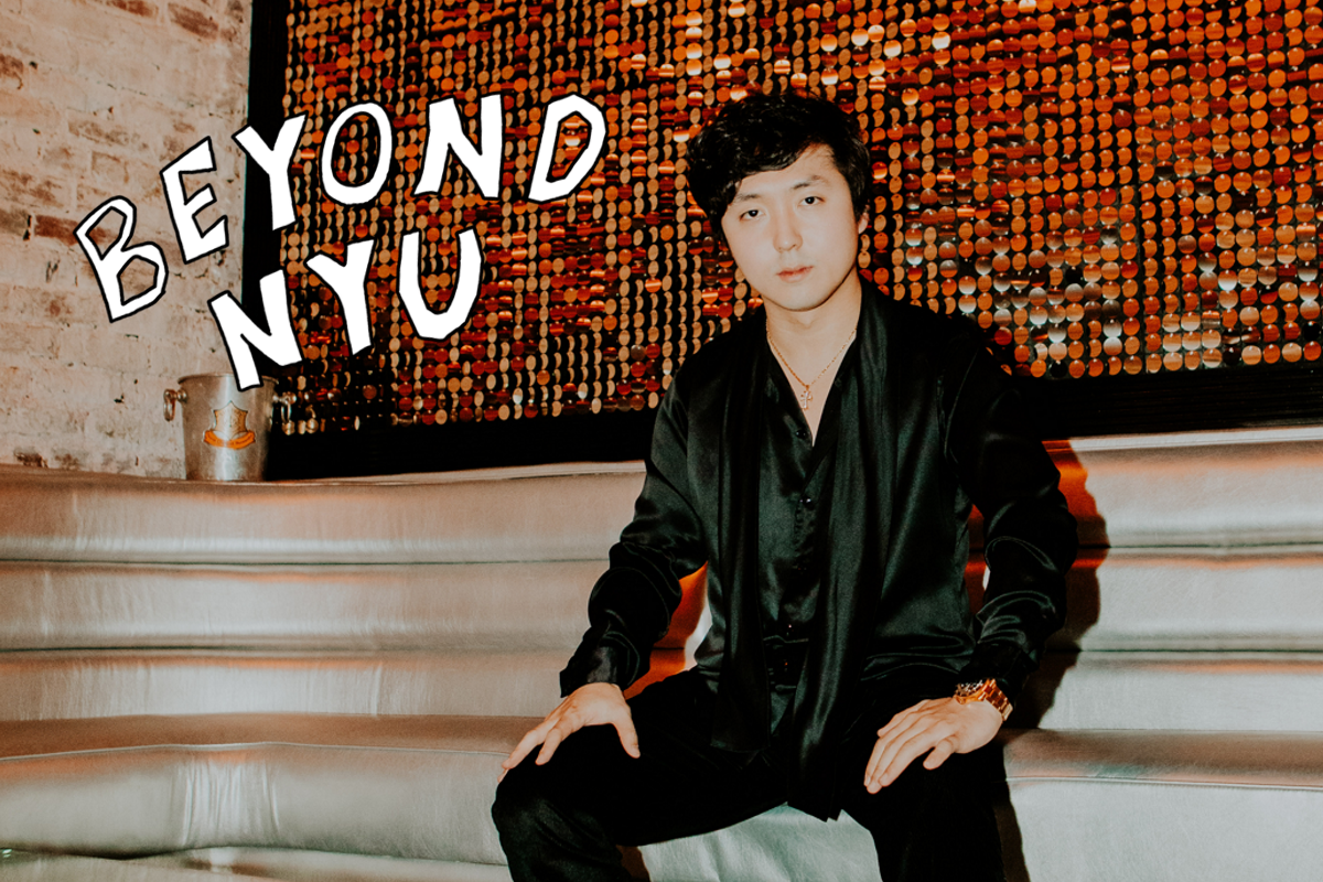An image of Mir Hwang dressed in all black sitting on a white couch with the hand-drawn words “BEYOND N.Y.U.” next to him.