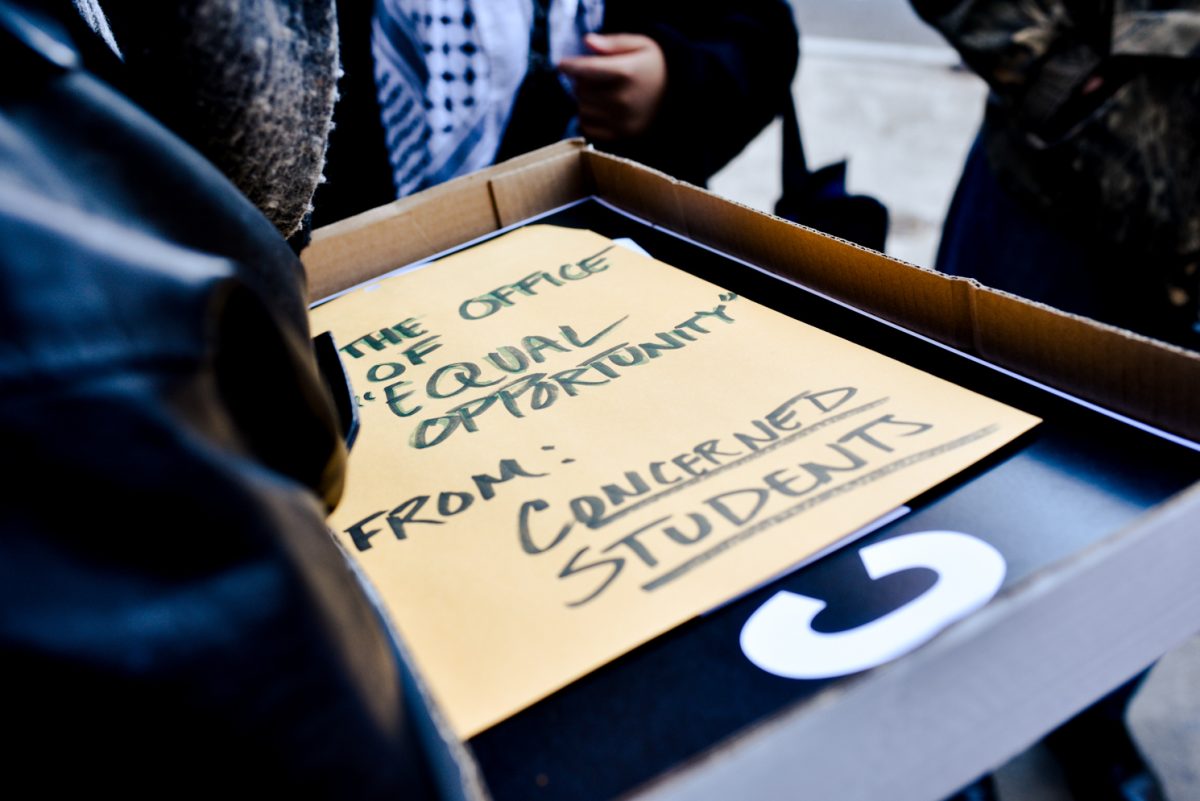 A box with a paper saying THE OFFICE OF EQUAL OPPORTUNITY and FROM: CONCERNED STUDENTS.
