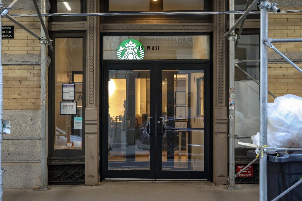 Exterior shot of a Starbucks with two glass doors. The green Starbucks logo is visible through the top window.