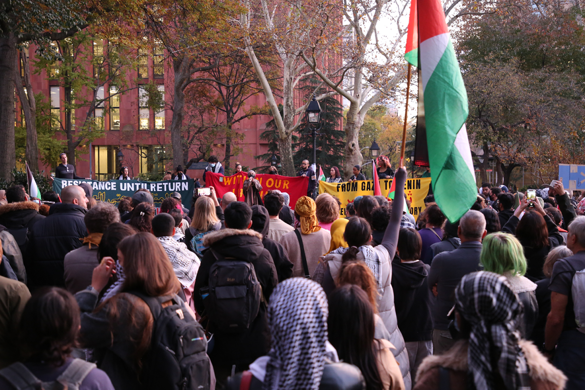 A group of people gathered in Washington Square Park for a protest.