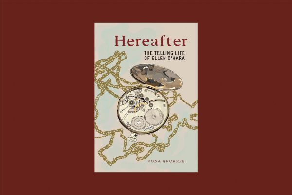 Beige book cover on a burgundy background titled “HEREAFTER: THE TELLING LIFE OF ELLEN O’HARA” in red and brown font. There is an open-faced pocket watch with a long brass chain. “VONA GROARKE” is written in the bottom corner in red font.