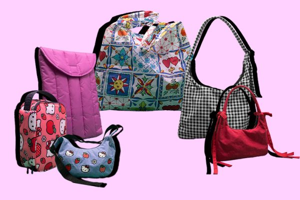 Patterned and solid-colored nylon bags, laptop cases and lunchboxes on a pink background.