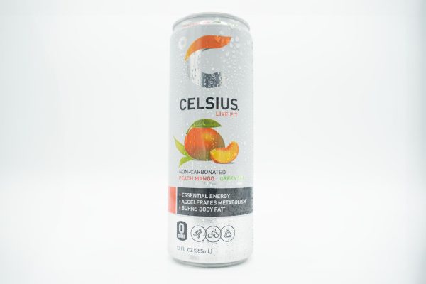 A wet white can of Celsius energy drink in Peach Mango flavor.