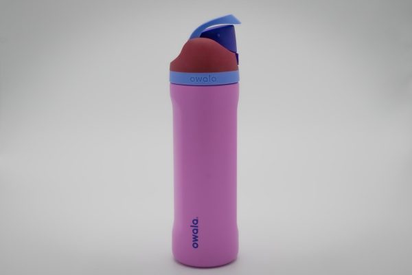 A pink water bottle with a red and blue lid against a white background.