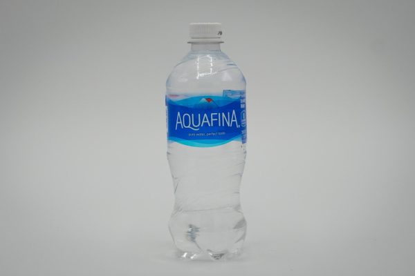 A plastic water bottle with “AQUAFINA” written on it, against a white background.