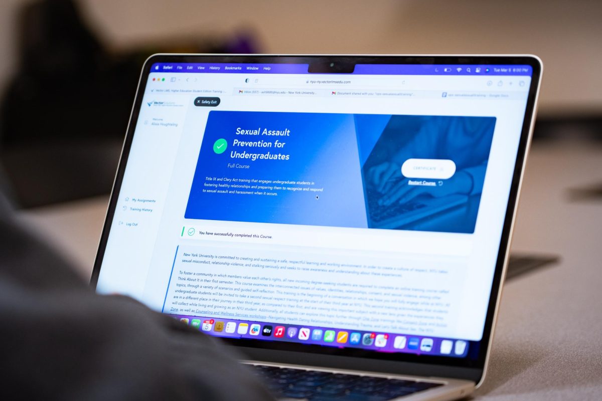 A person sitting in front of a laptop whose screen is displaying a sexual assault prevention training portal.