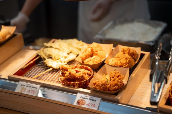 A tray with pieces of fried chicken. In front of the tray there are two labels, “Tender chicken Breast” and “Chicken Karaage.”