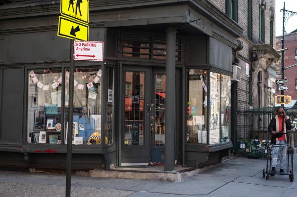 The exterior of a corner building that is painted black.