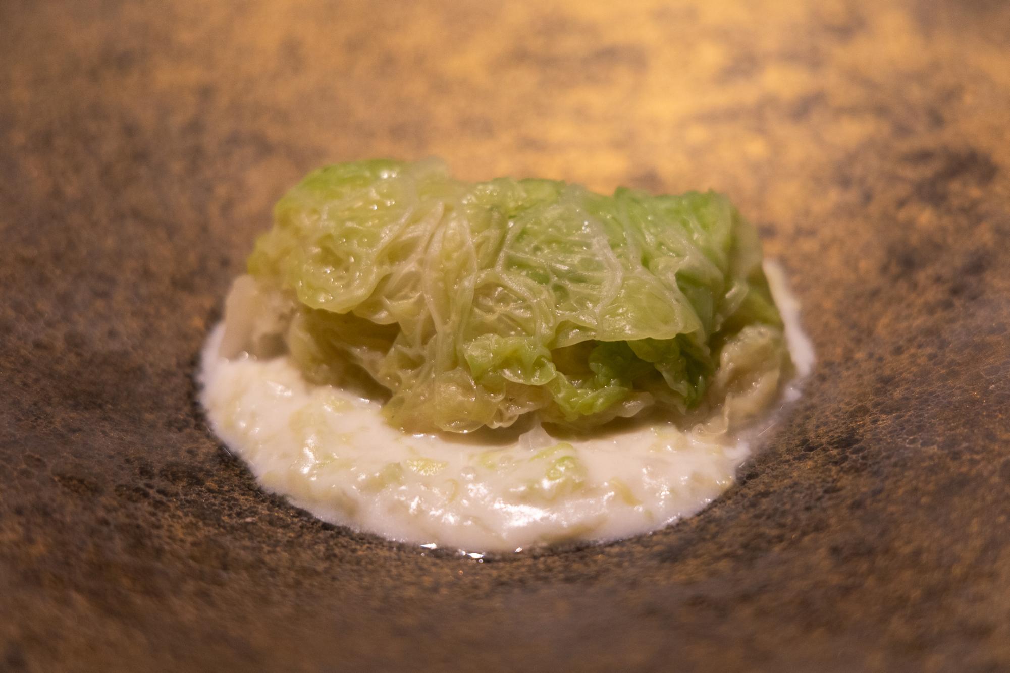 A piece of cabbage and blue cheese.