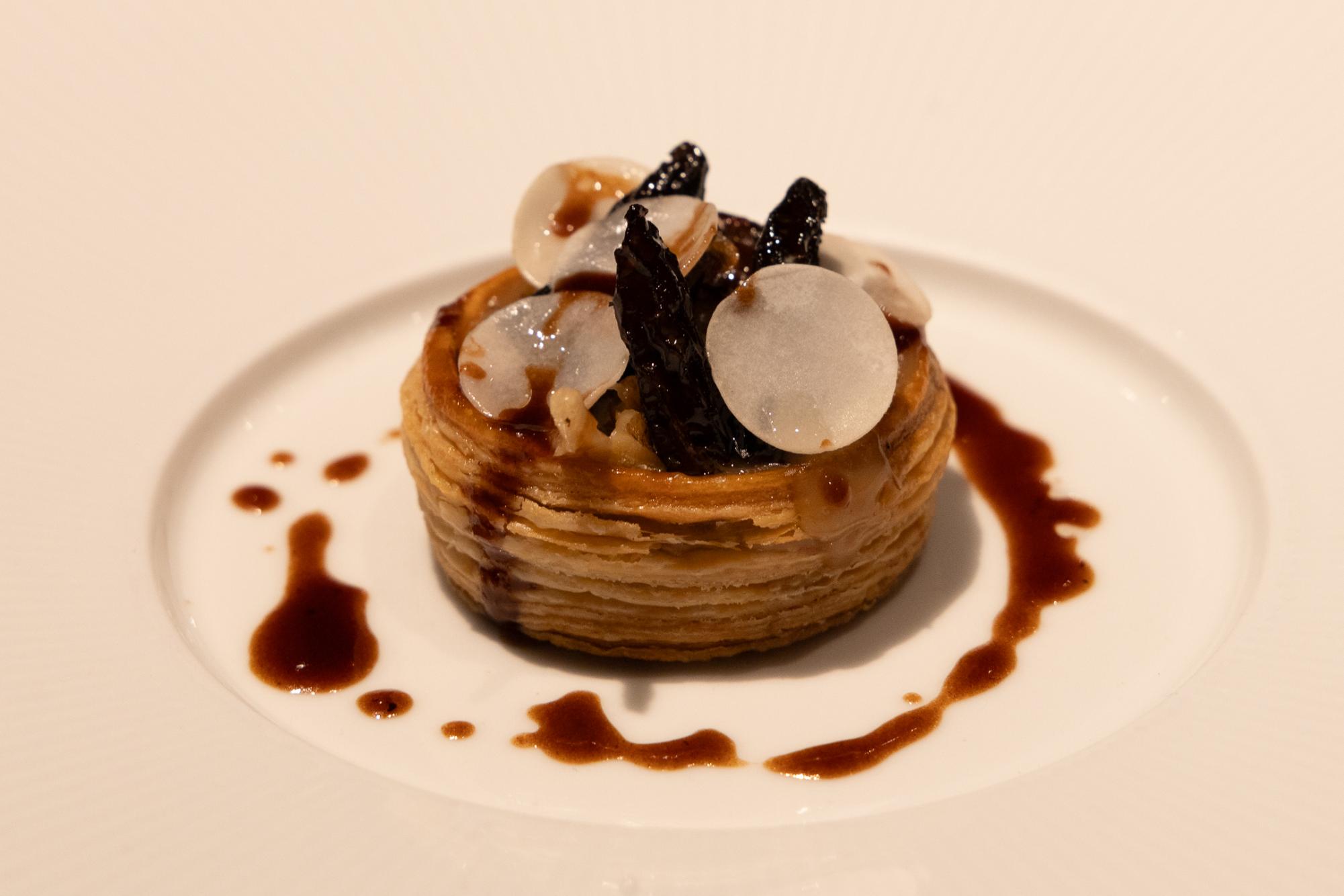 Pastry with mushrooms and brown sauce.